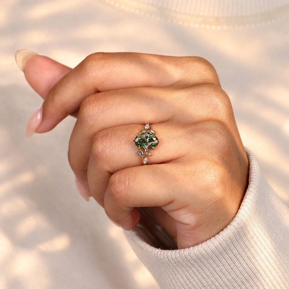 Handmade green diamond ring with twisted bypass shank.