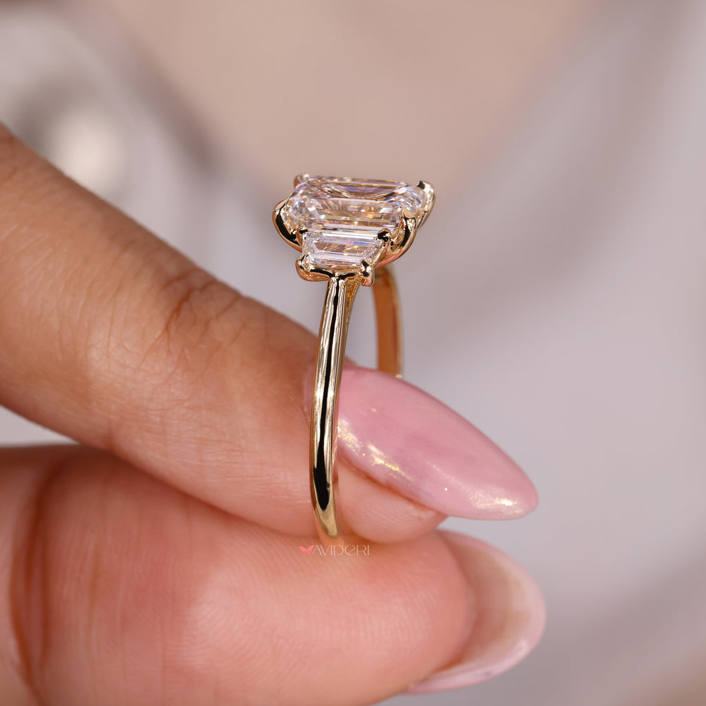 Yellow gold engagement ring featuring a dazzling emerald cut diamond ring design.

