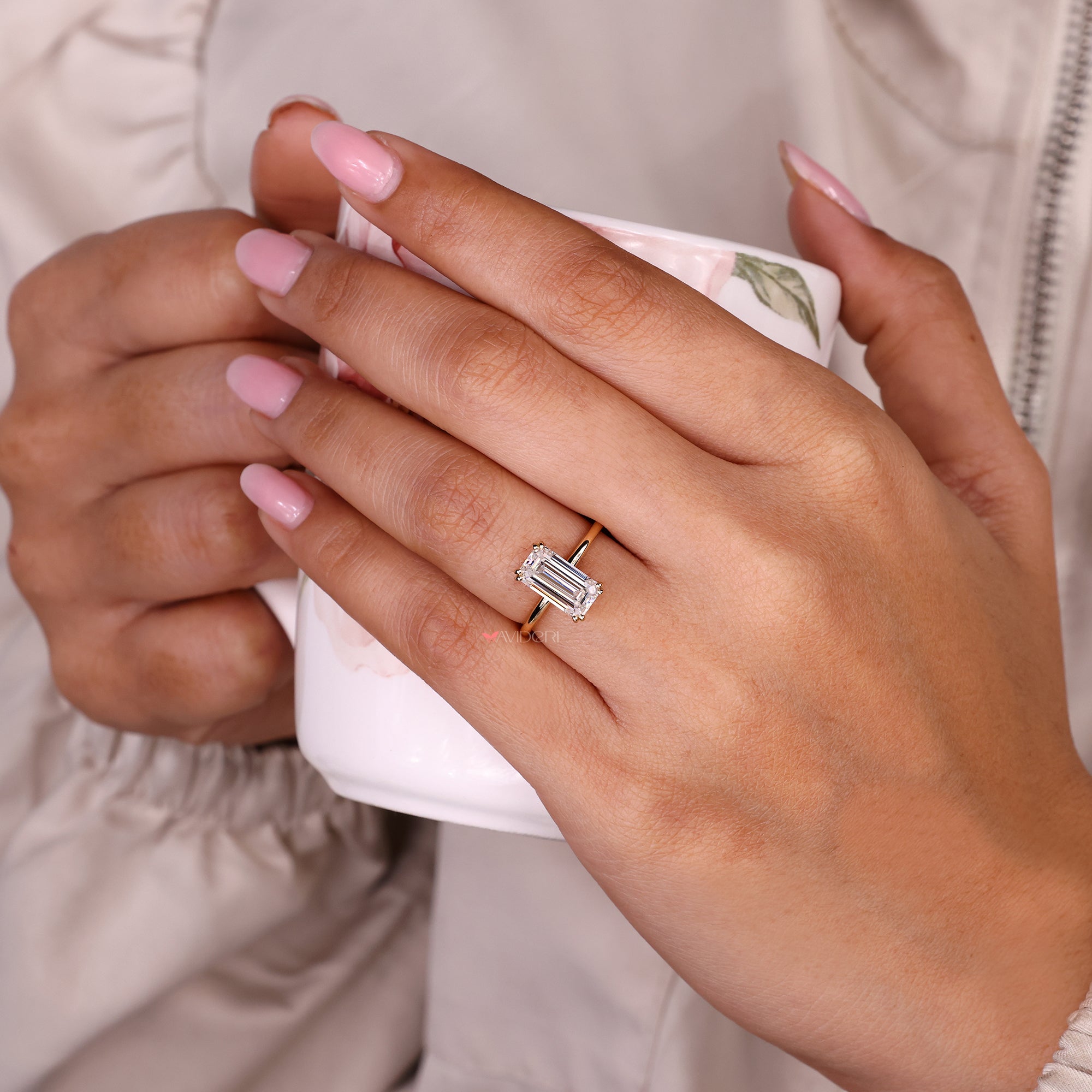 Emerald cut moissanite ring with double prongs.
