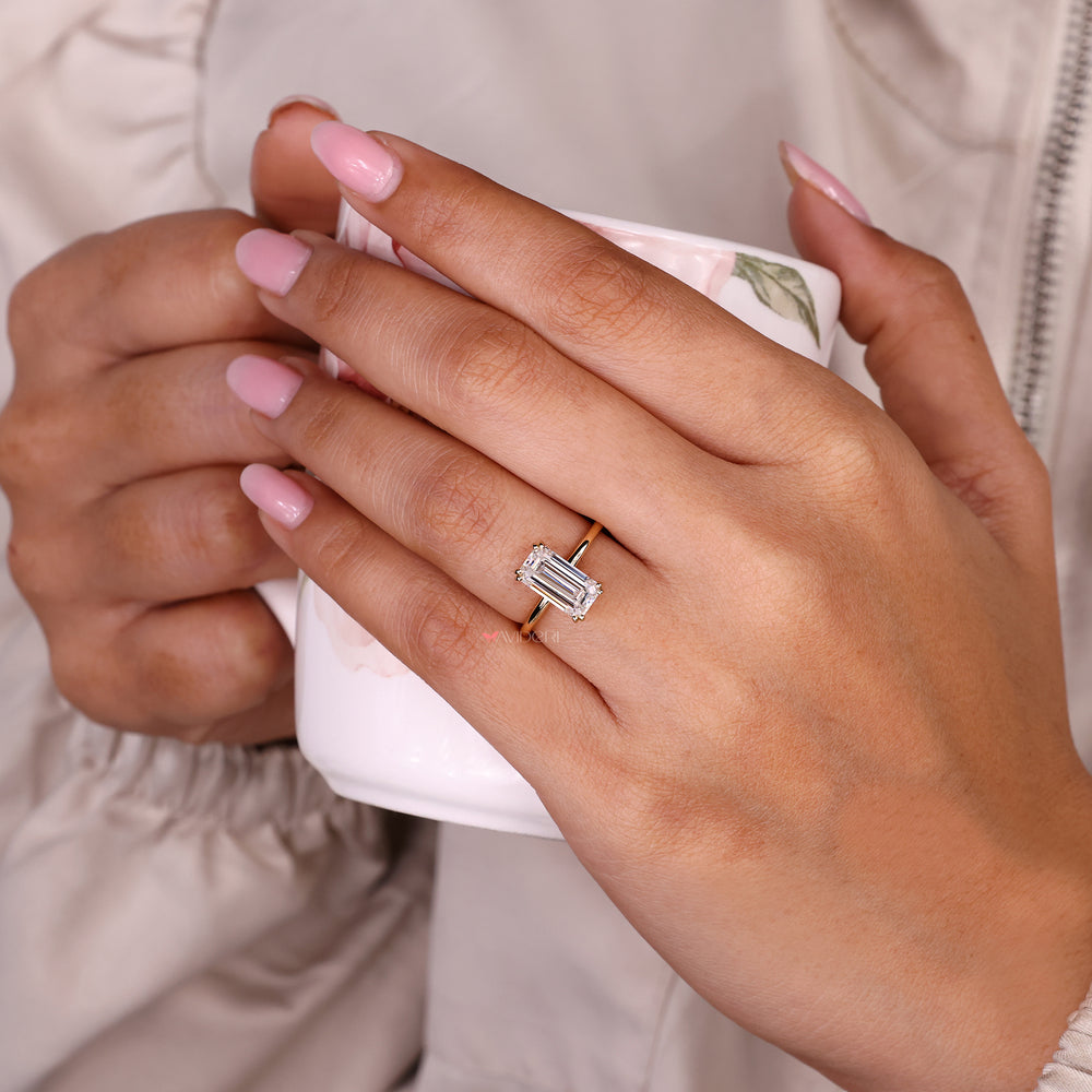 Emerald cut moissanite ring with double prongs.
