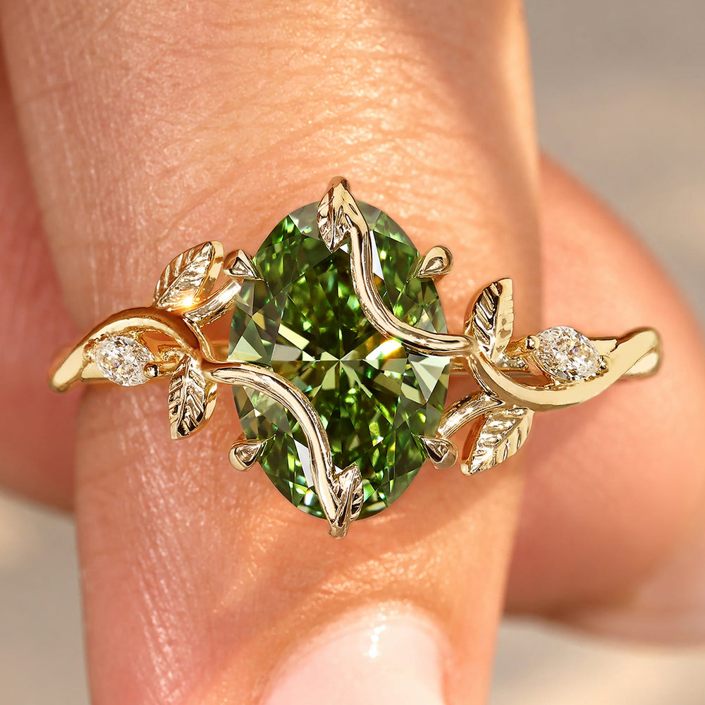 Oval green diamond engagement ring with twisted shank.