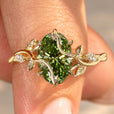 Oval green diamond engagement ring with twisted shank.