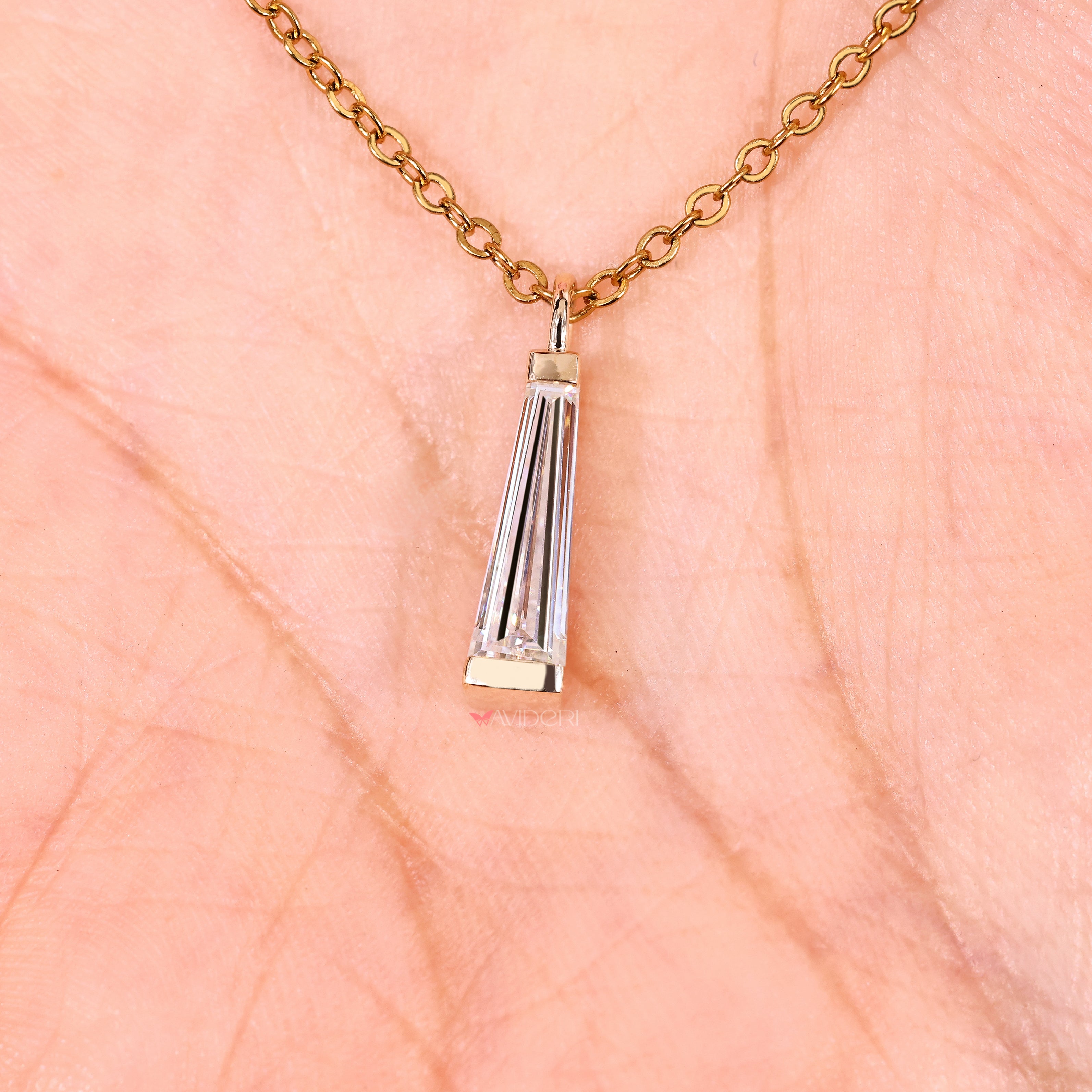 Moissanite solitaire necklace with tapered baguette side stones.

