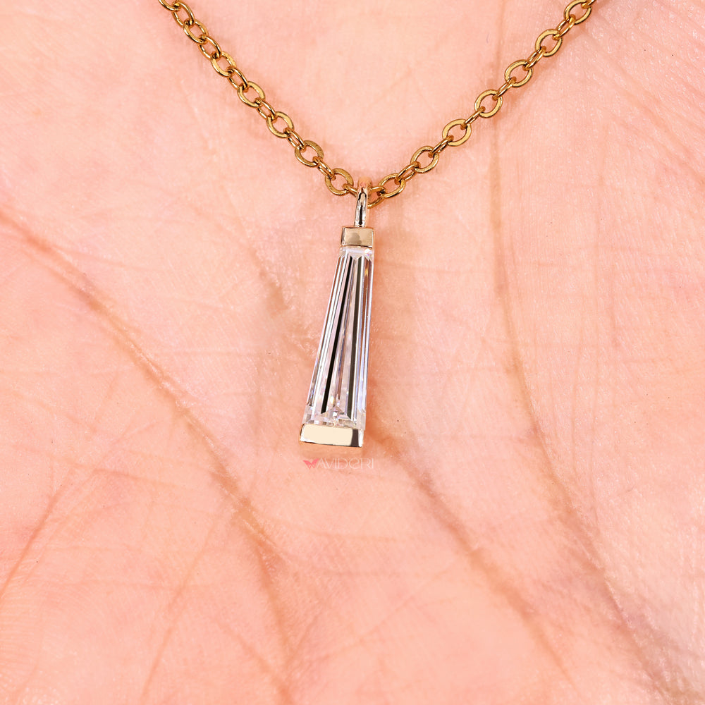 Moissanite solitaire necklace with tapered baguette side stones.
