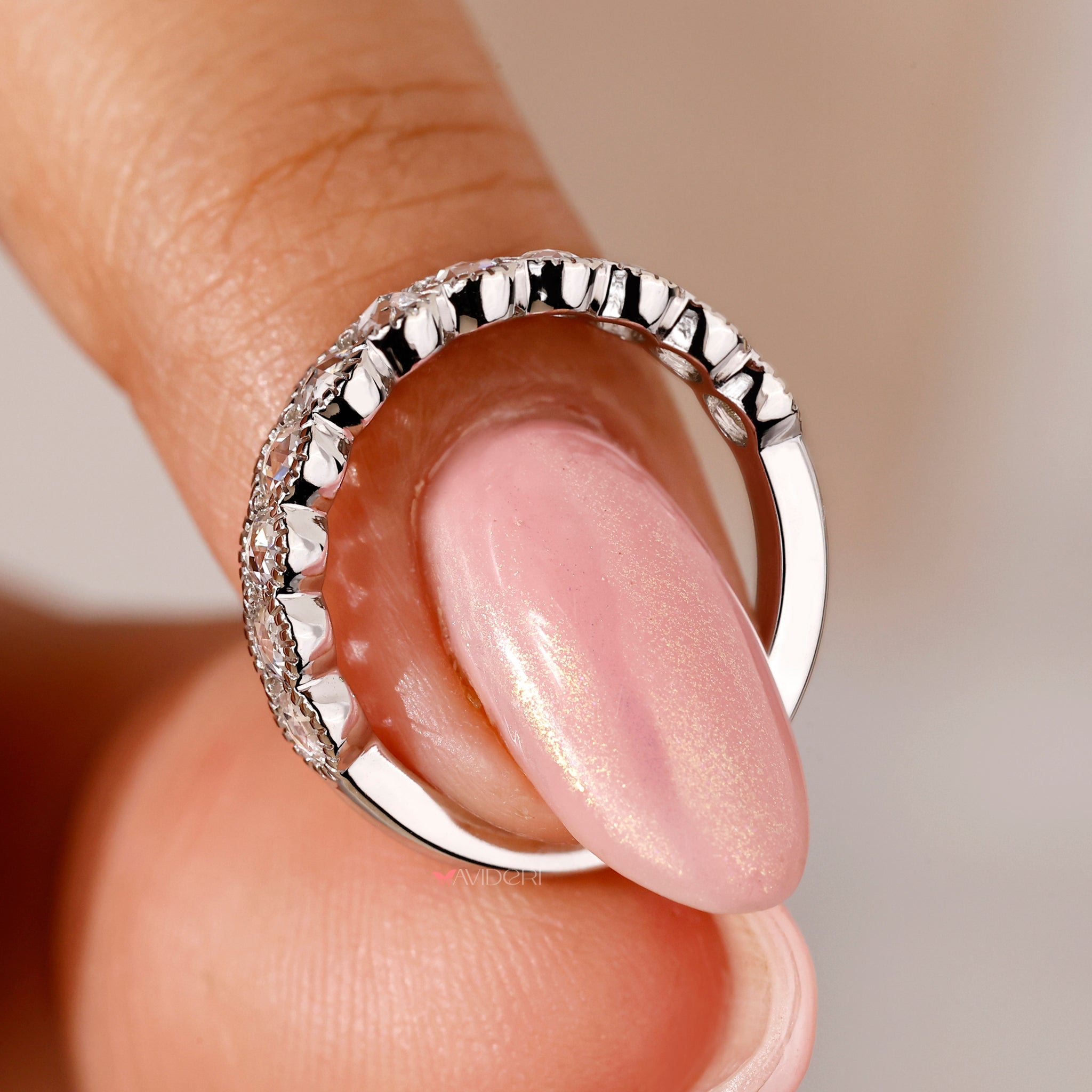 White gold wedding band featuring a milgrain design and round diamonds.
