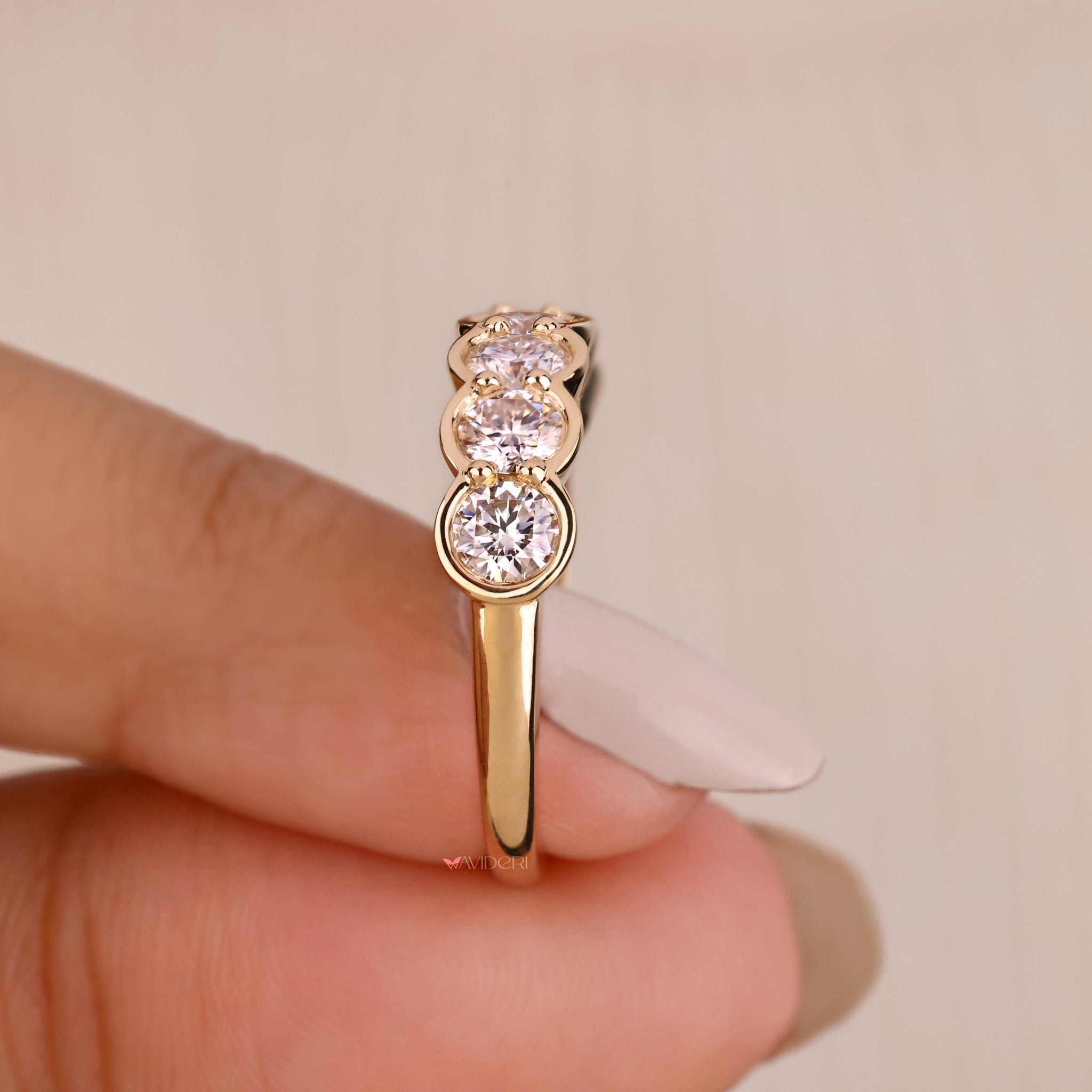 Custom wedding band from Avideri with round stones.
