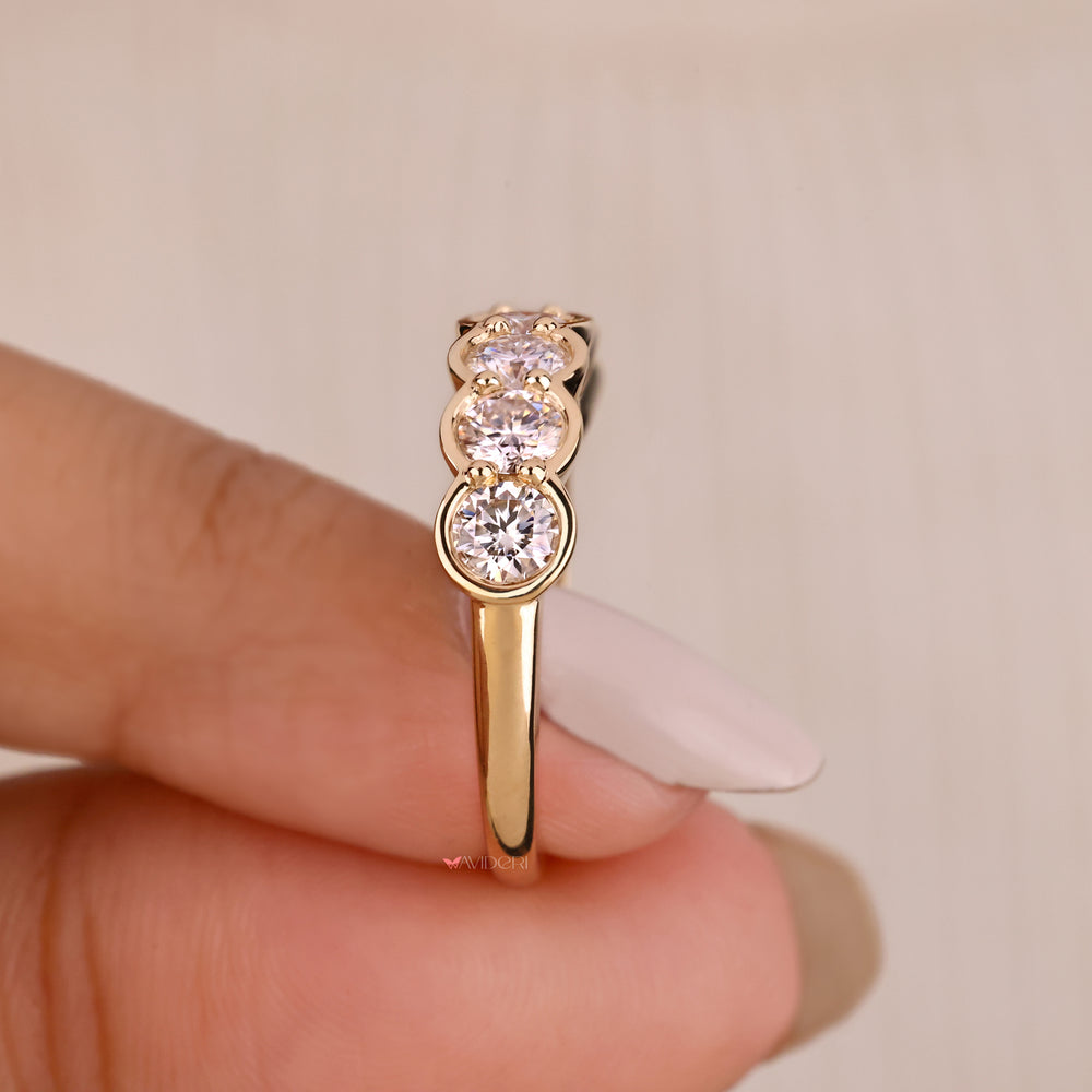 Custom wedding band from Avideri with round stones.
