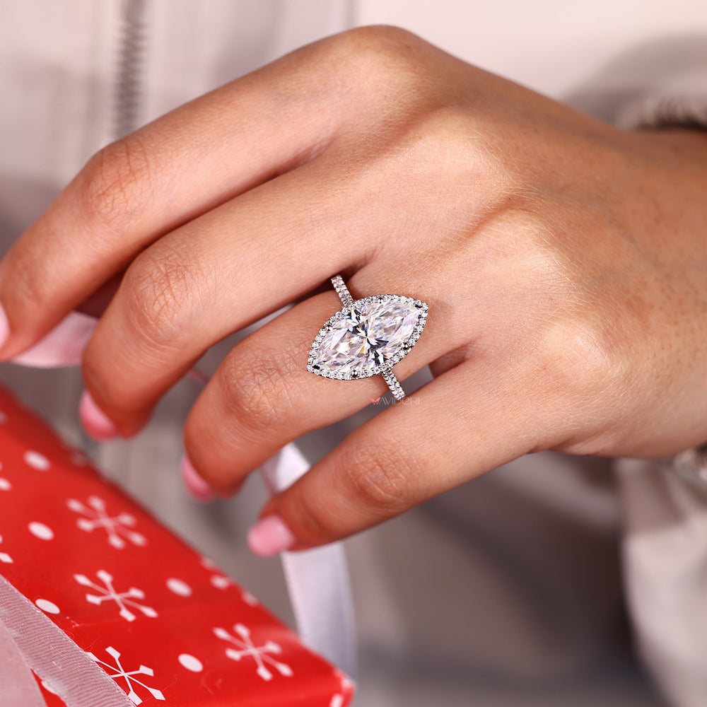 Marquise ring with halo and pave style round moissanite.