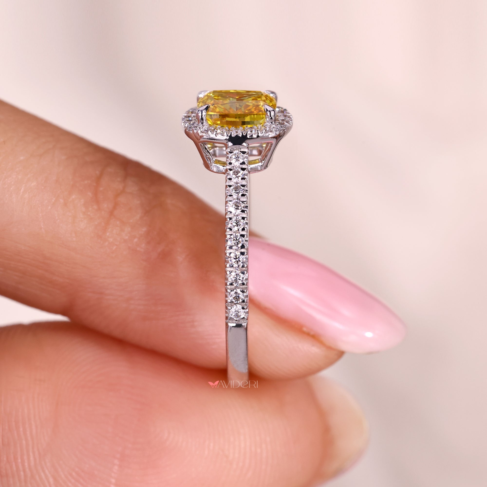 Yellow cushion cut diamond ring with cathedral setting.
