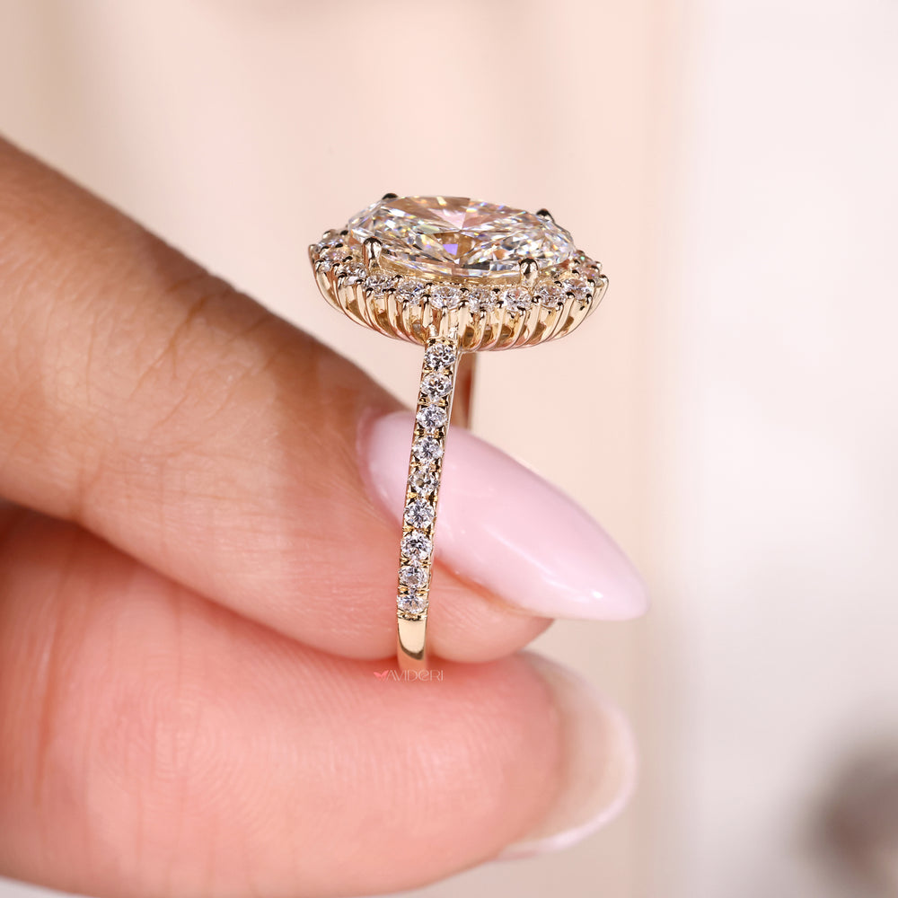 Round engagement ring featuring a unique oval diamond center stone.
