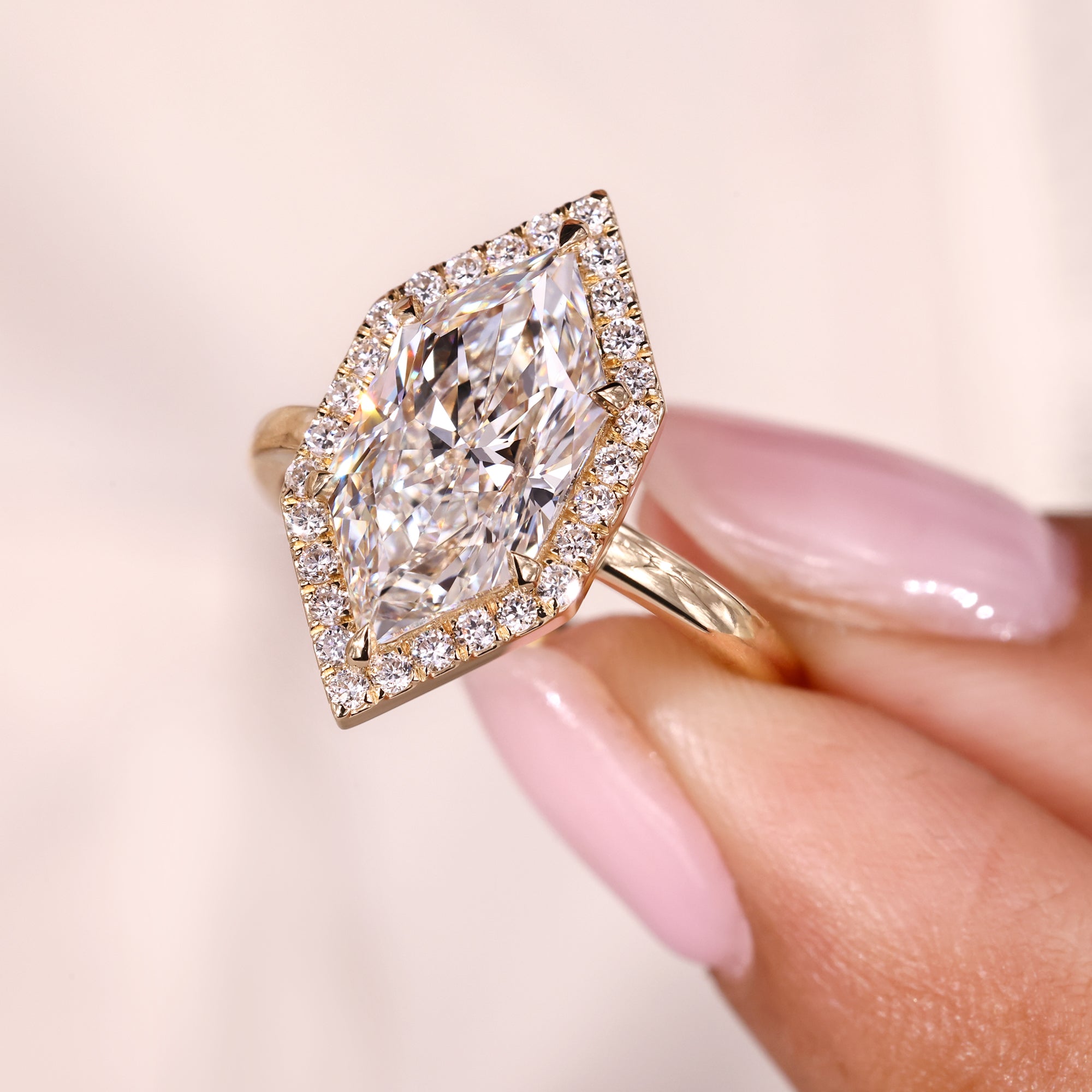 Round cut halo setting with yellow gold diamond ring.