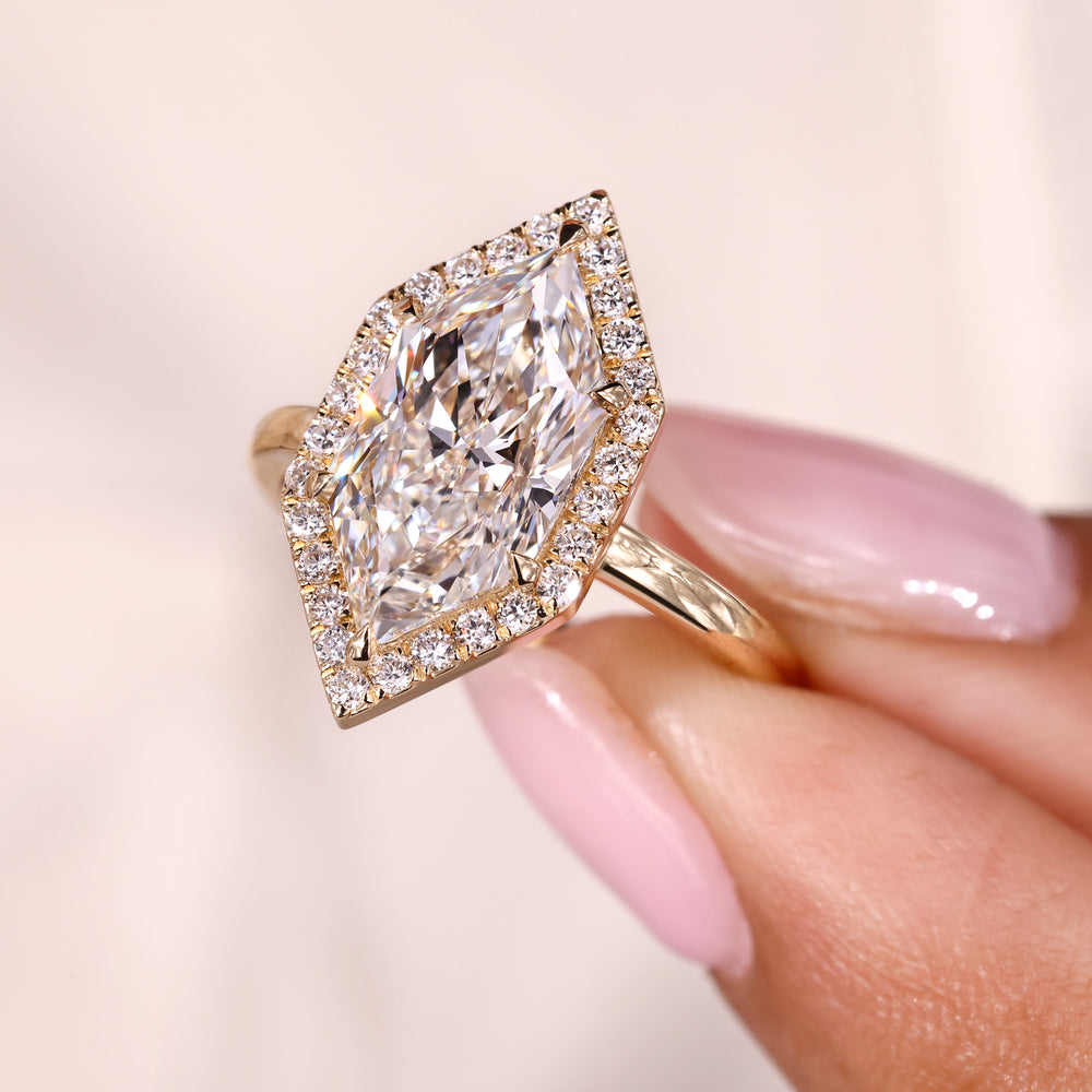 Round cut halo setting with yellow gold diamond ring.