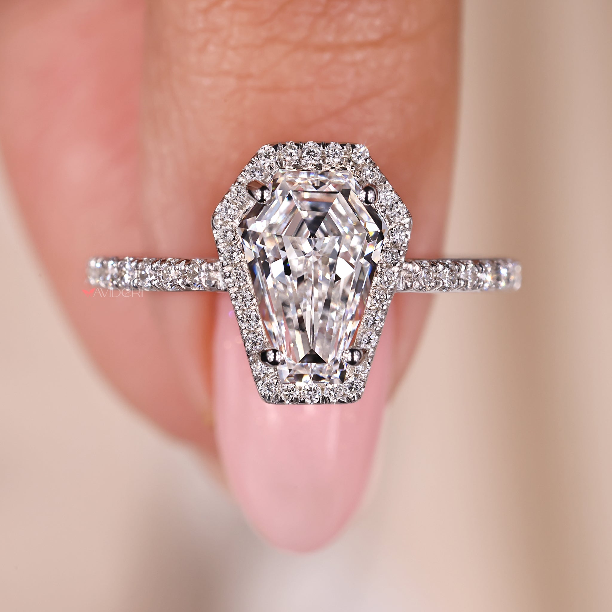 Coffin engagement ring with a unique round cut pave setting.