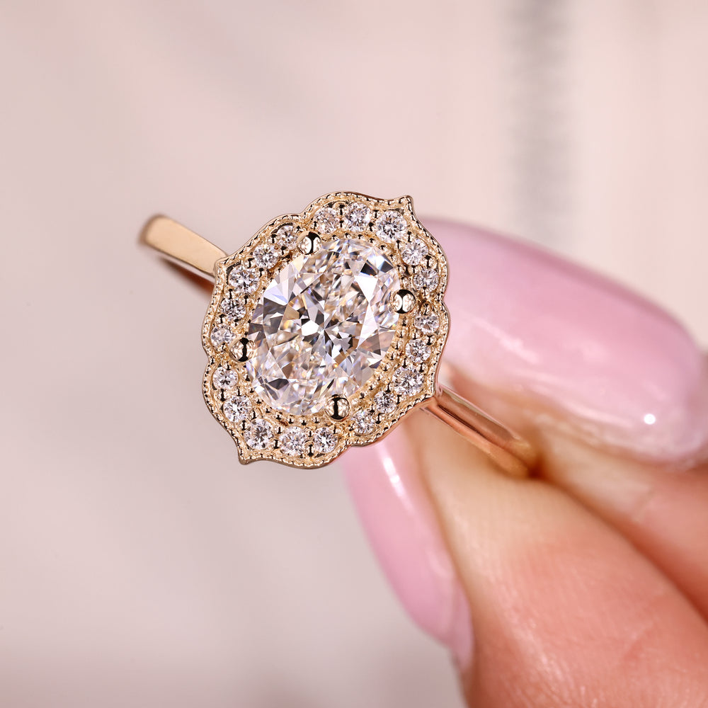 Vintage oval diamond ring with round halo accents.