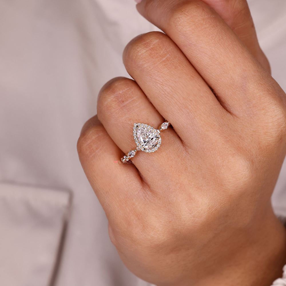Pear diamond ring with marquise side stones.
