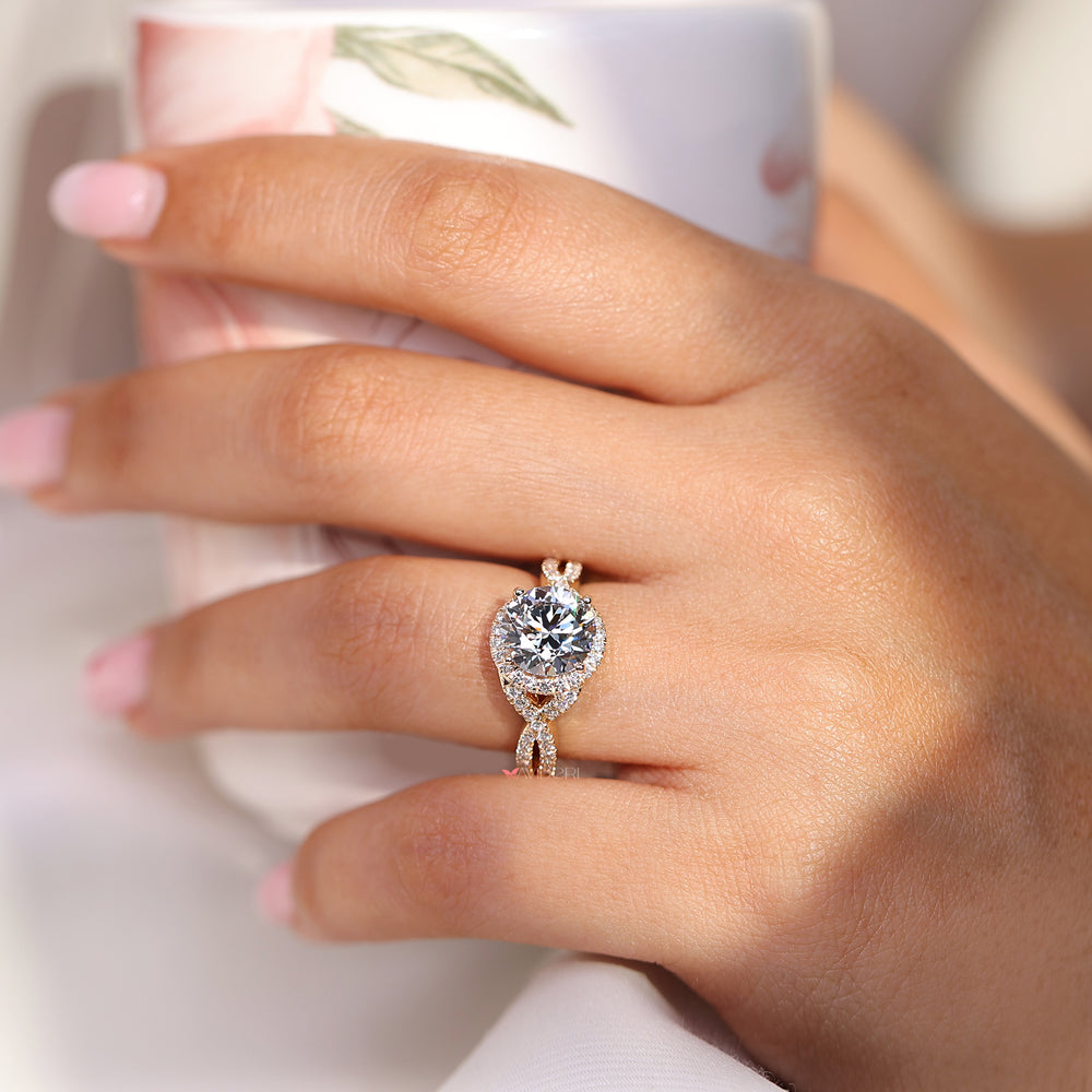 Round diamond engagement ring with twisted shank design.