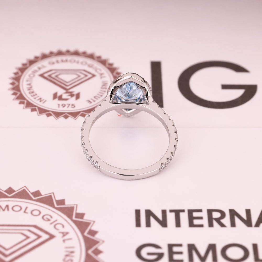 Marquise cut blue diamond ring with four claw prongs
