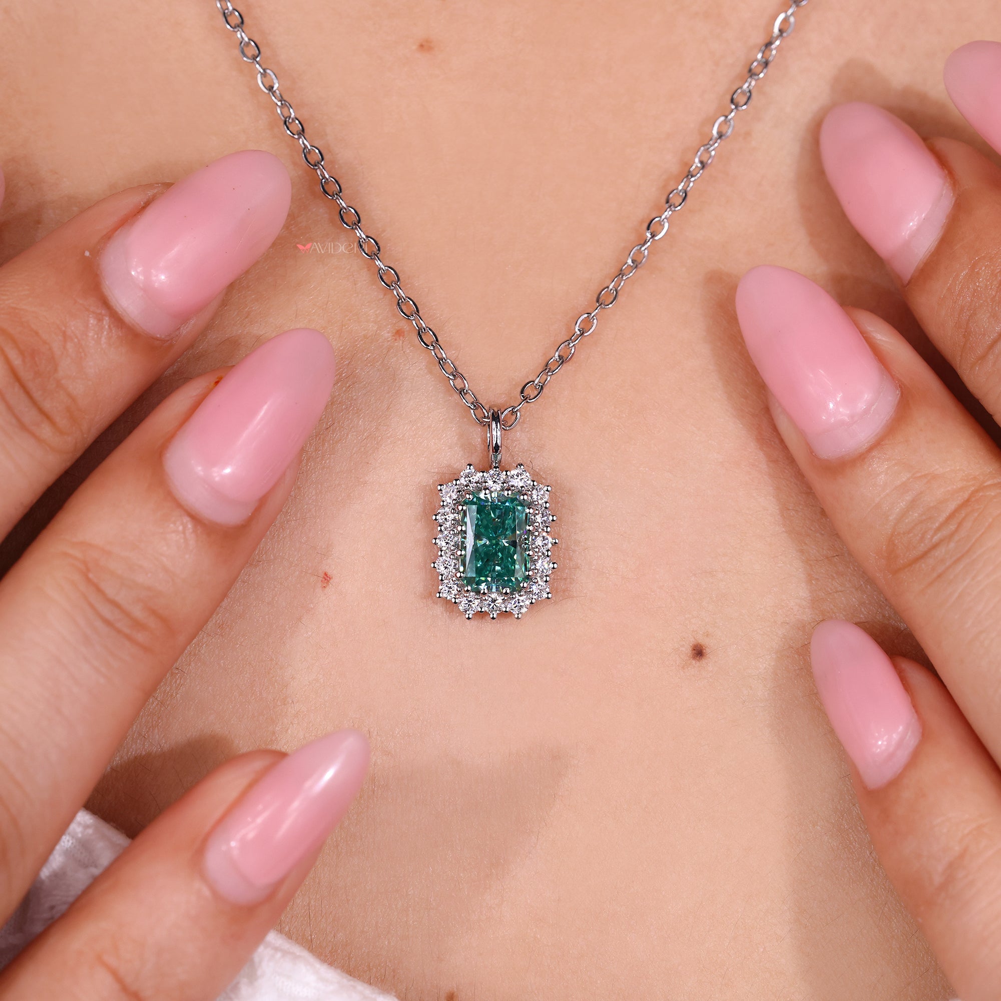Radiant cut pendant with round moissanite halo.
