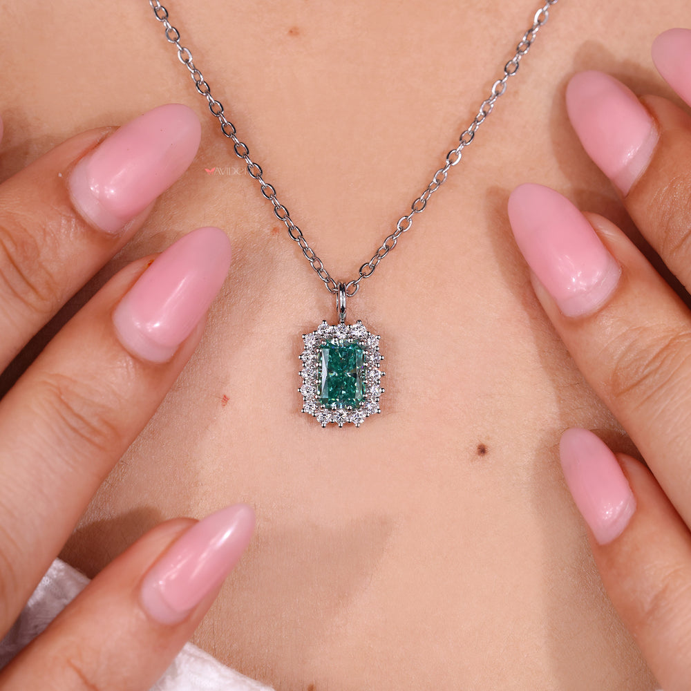 Radiant cut pendant with round moissanite halo.
