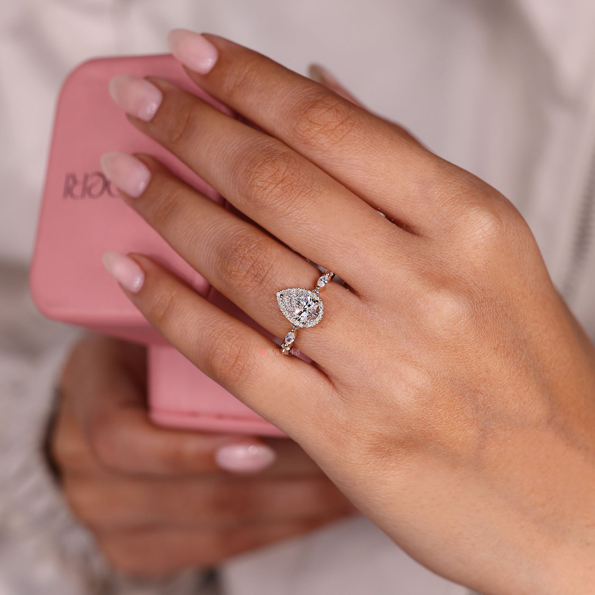 Pear diamond engagement ring with marquise pave.
