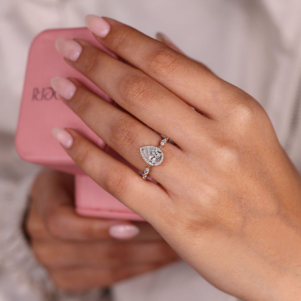 Pear diamond engagement ring with marquise pave.
