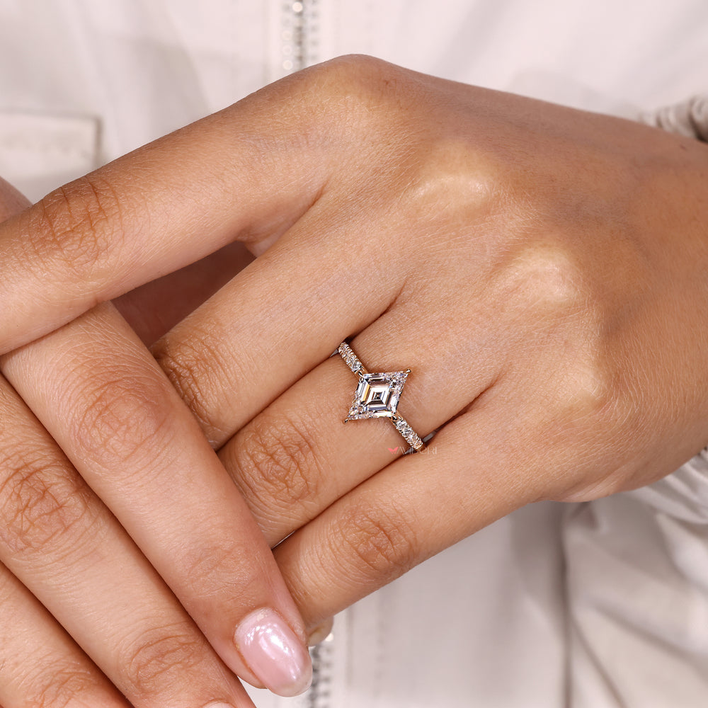Lozenge cut ring with round diamond accents.
