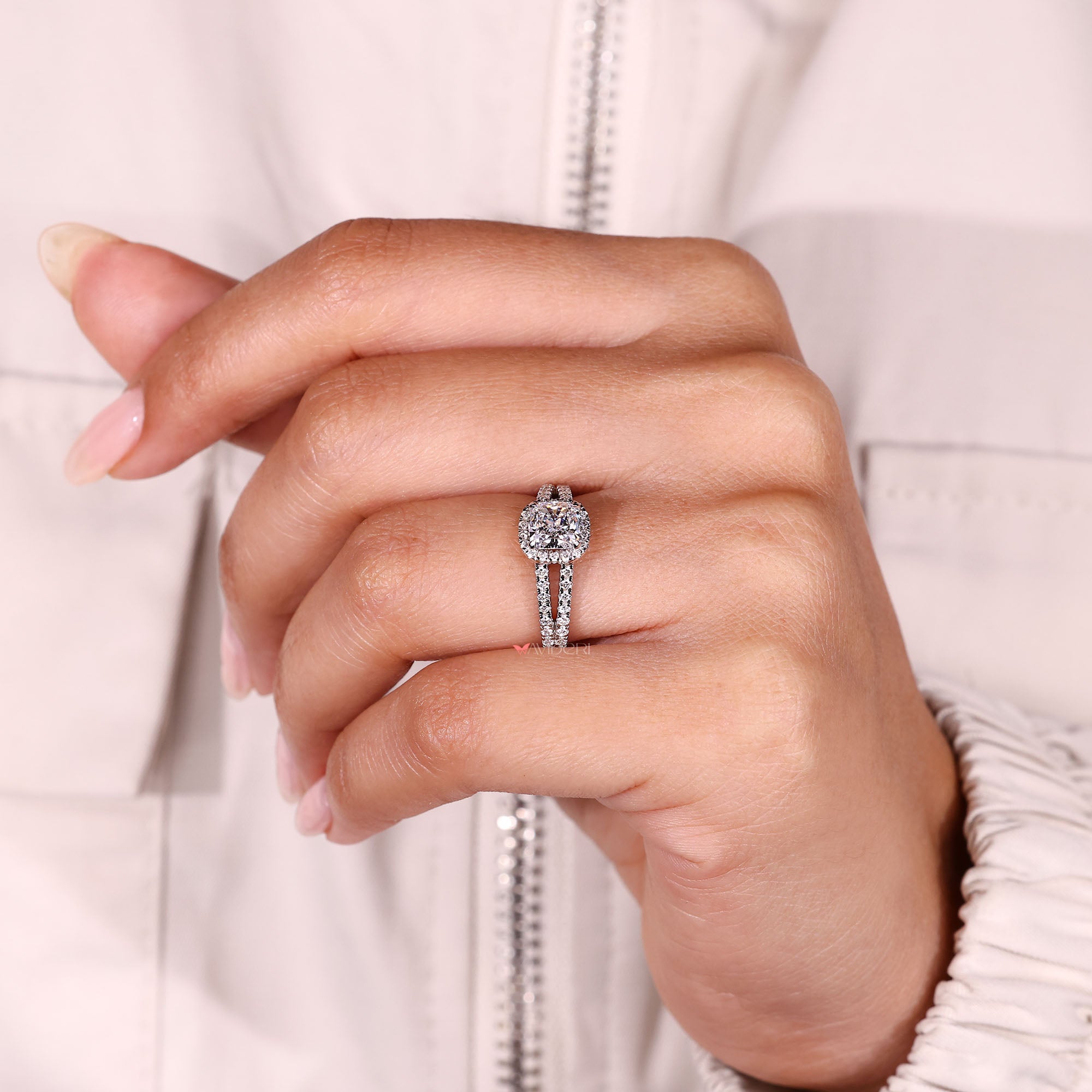 Cushion cut halo diamond ring with four claw prong setting.
