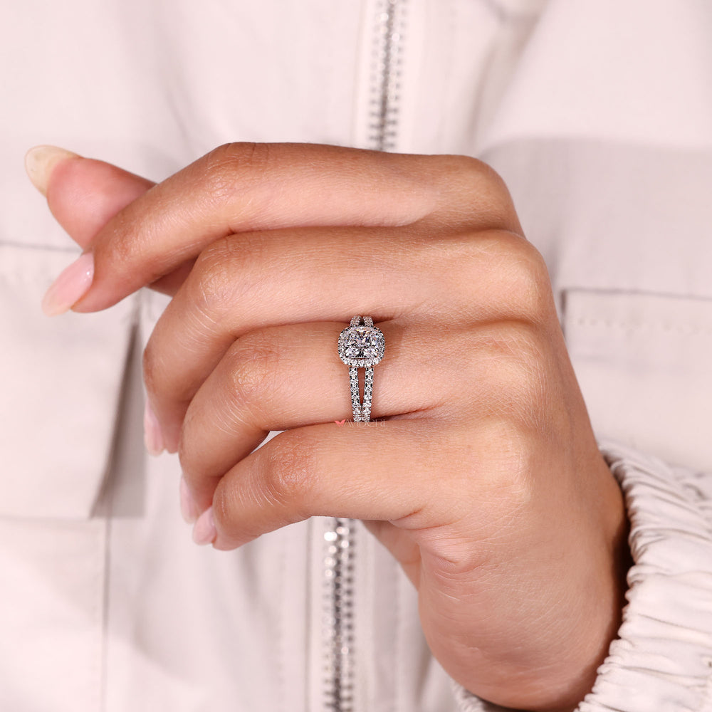 Cushion cut halo diamond ring with four claw prong setting.
