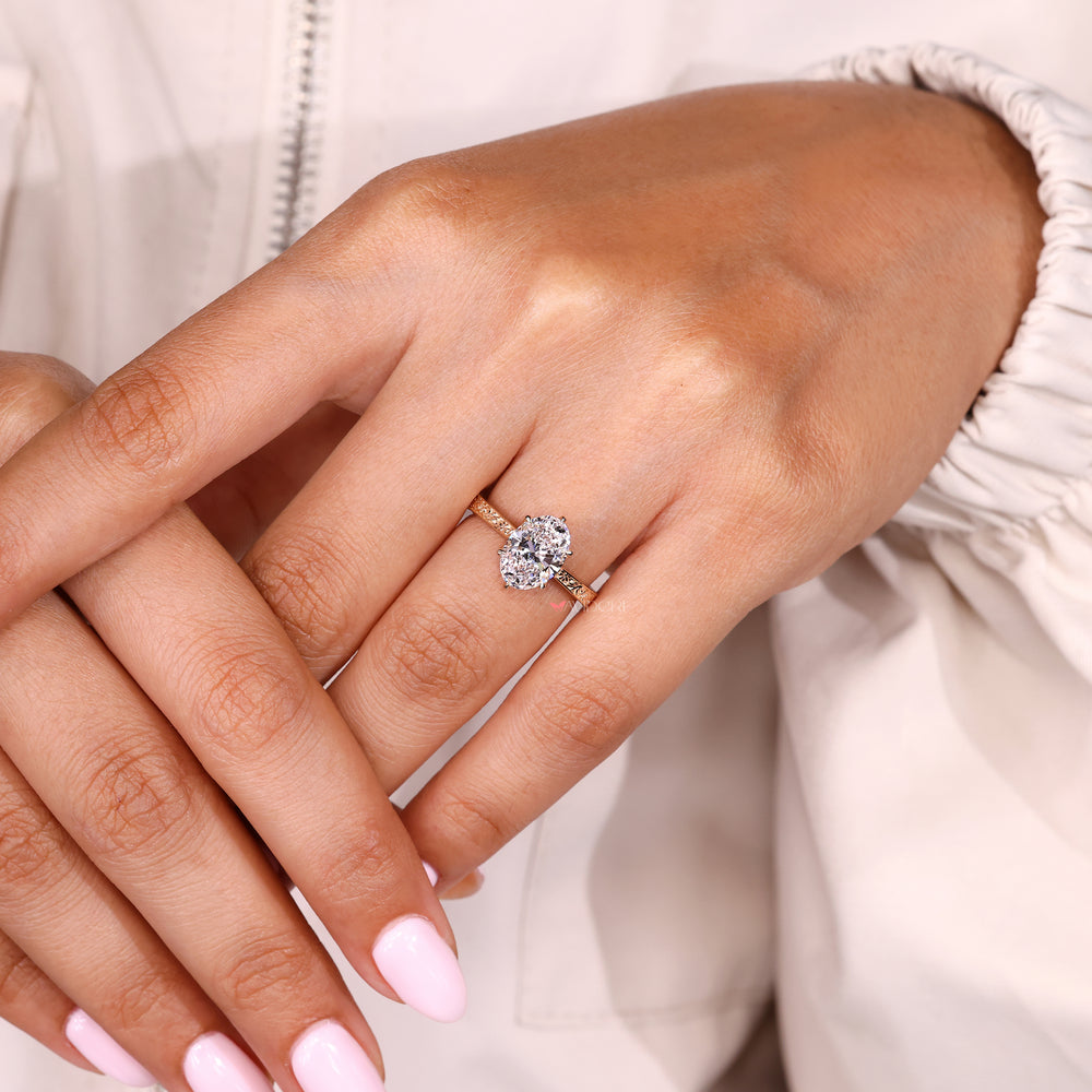 Vintage style oval diamond ring with pink ruby accents
