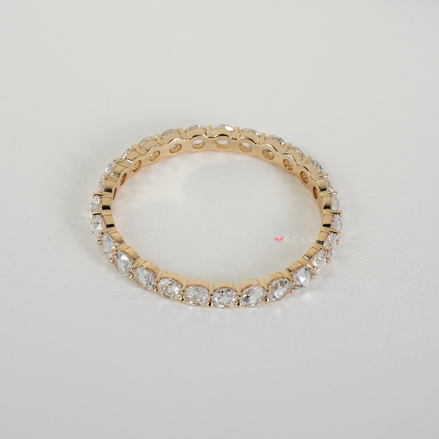 Eternity wedding band featuring round rose diamonds in prongs
