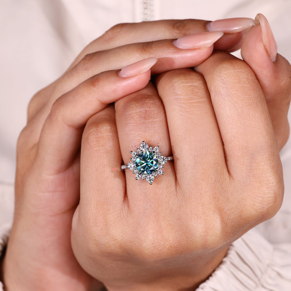 Round moissanite engagement ring with pave band.
