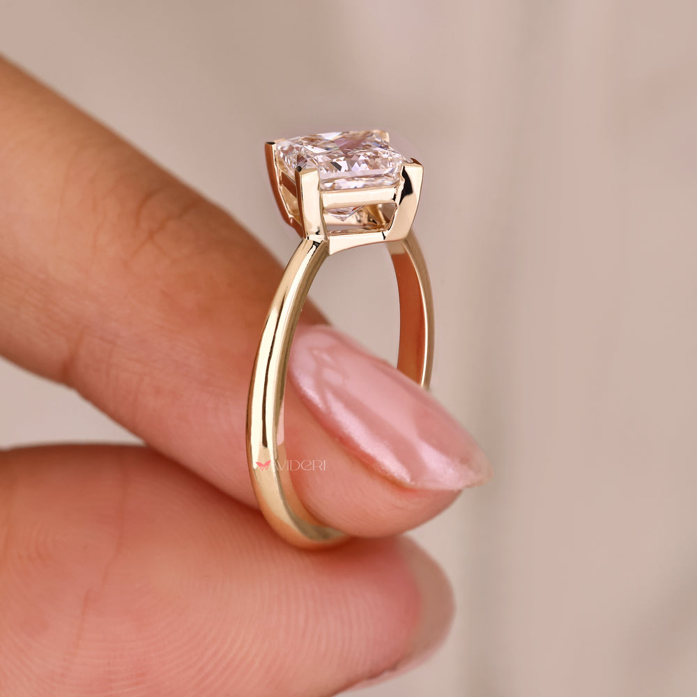 Princess cut ring with v prong solitaire design.
