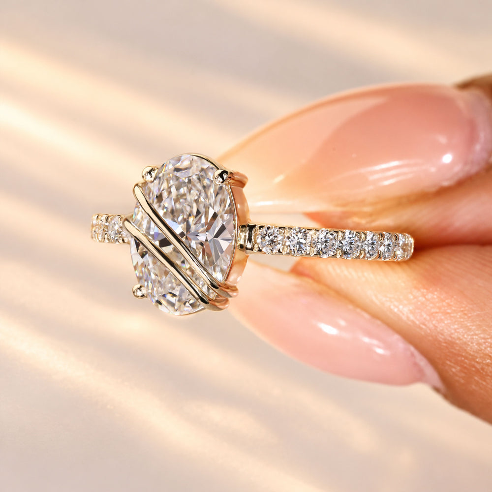 Oval engagement ring with regal pave detailing.
