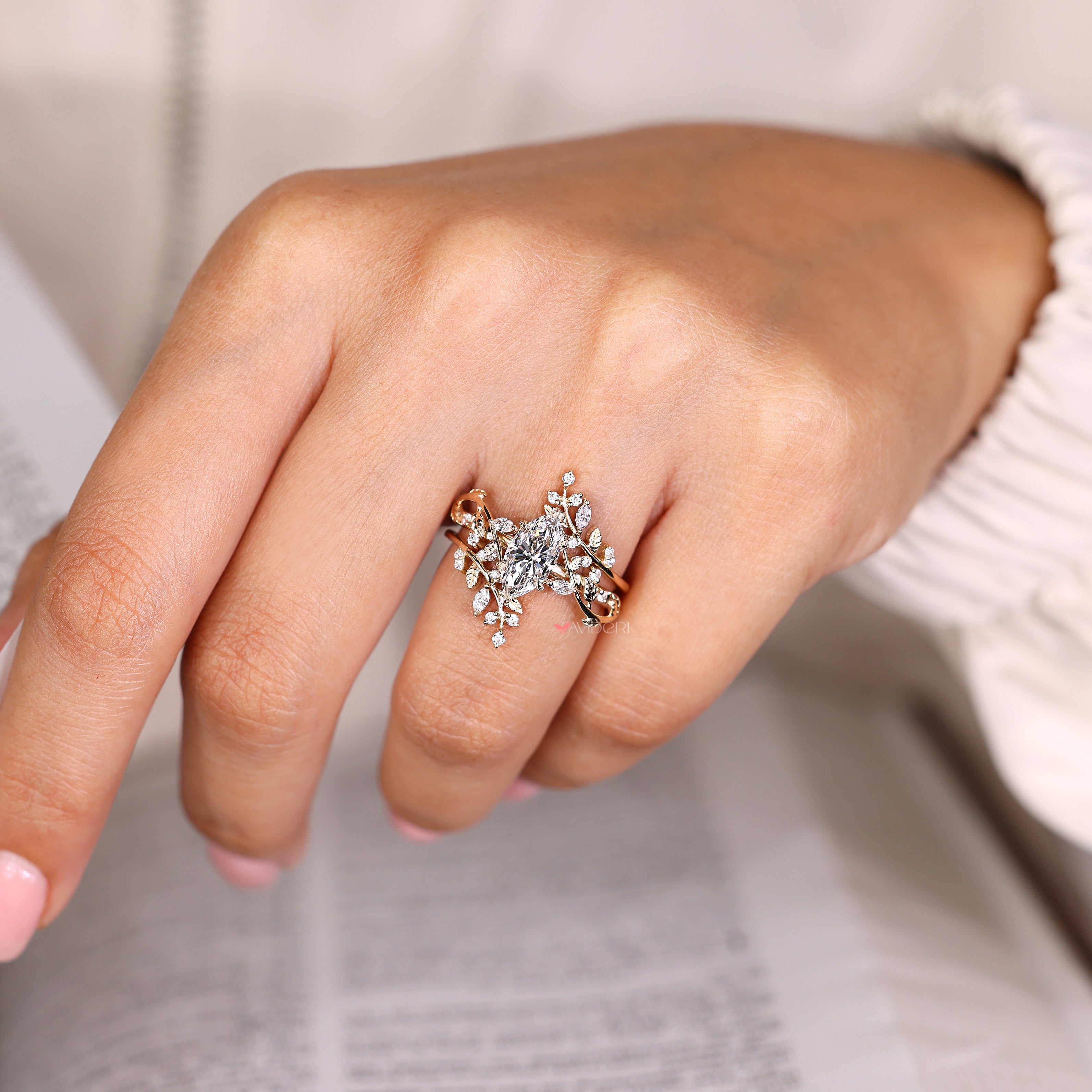 Marquise ring with leaf prongs and enhancer.
