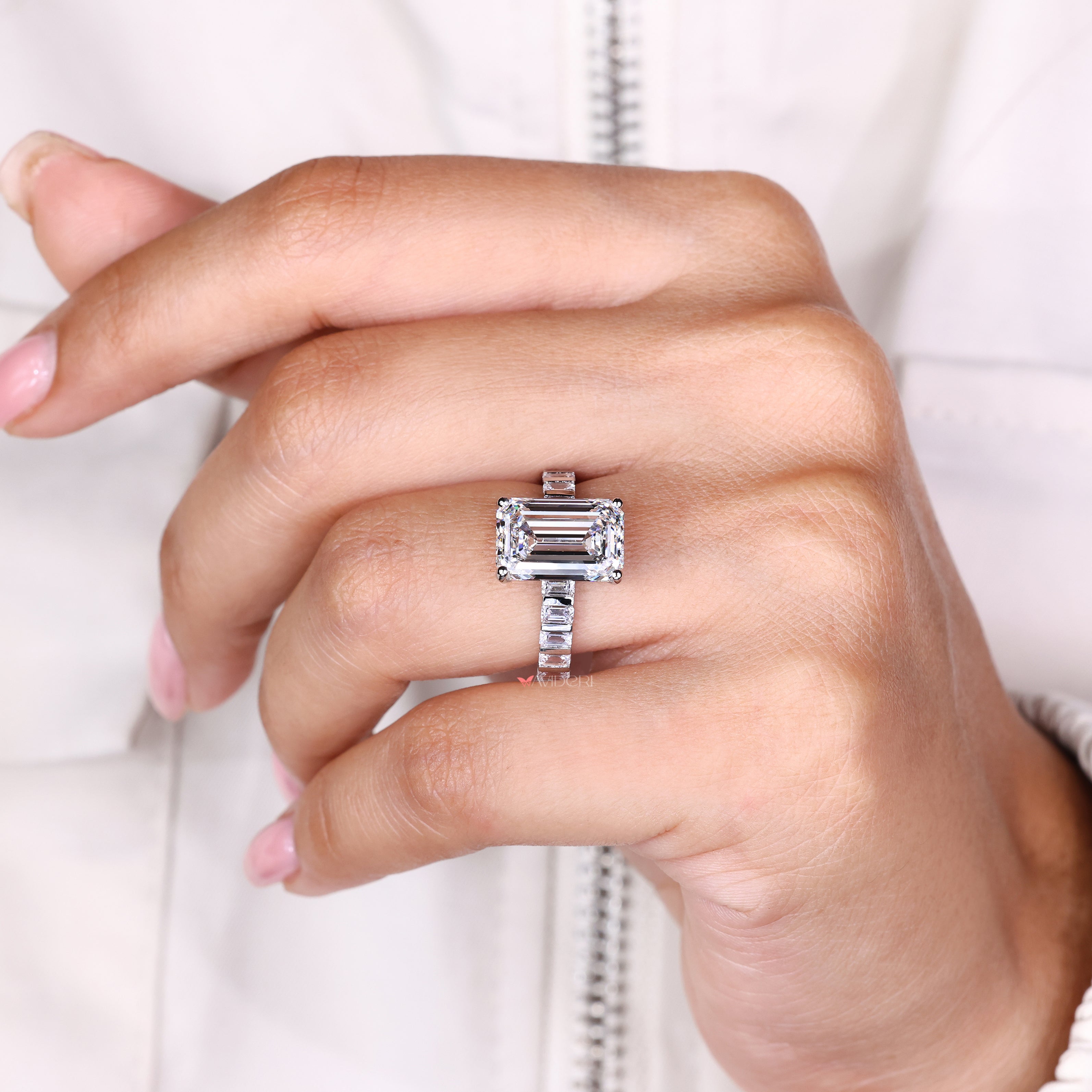 Handmade emerald diamond ring with bar set side stones
