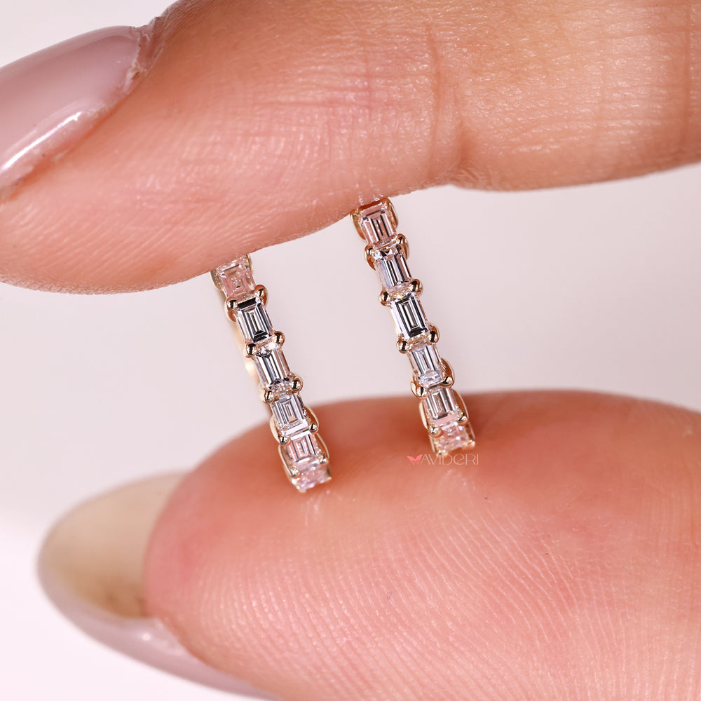 A pair of handmade white gold earrings with baguette stones
