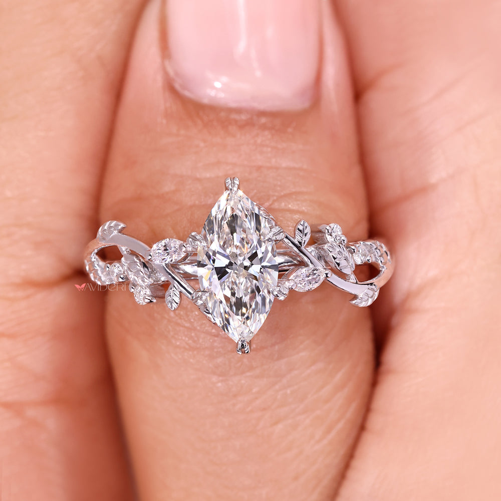 Marquise diamond ring with leaf setting and side stones.
