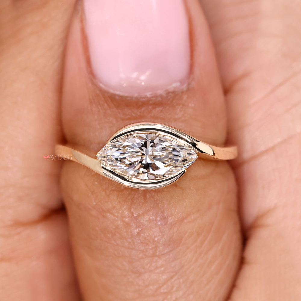 Solitaire marquise ring with east west style.
