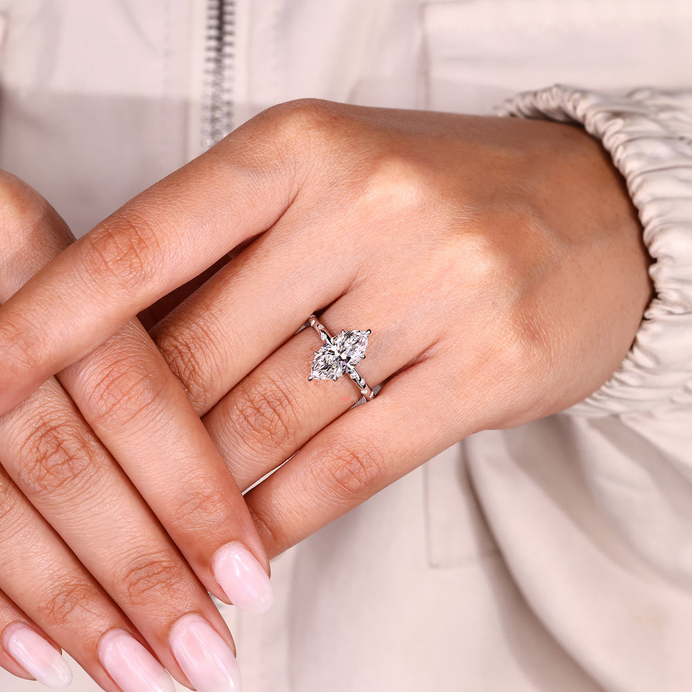 Modern marquise diamond ring with flush pave details.
