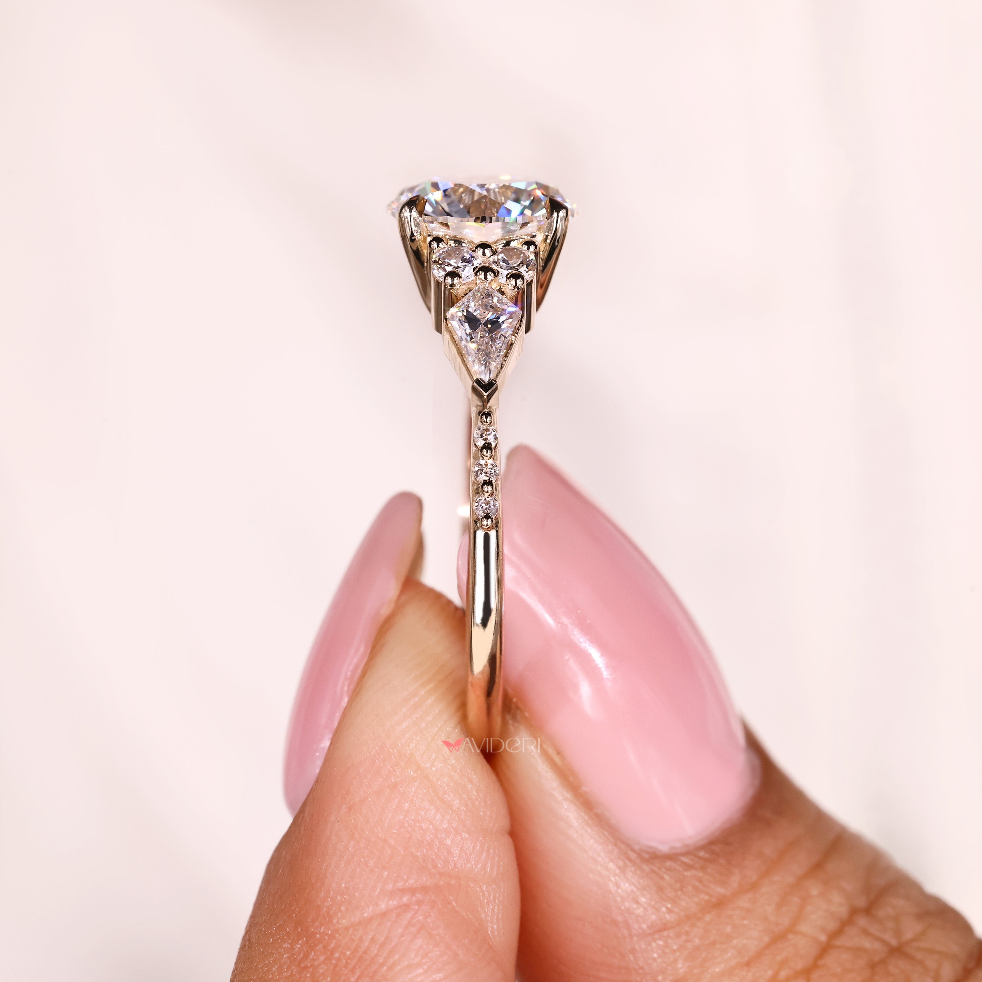 Round diamond engagement ring with kite and round accents
