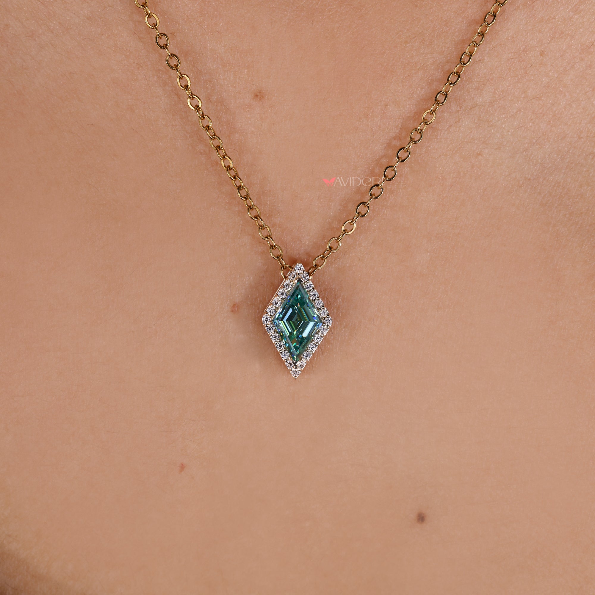 Cyan blue moissanite pendant in halo style.
