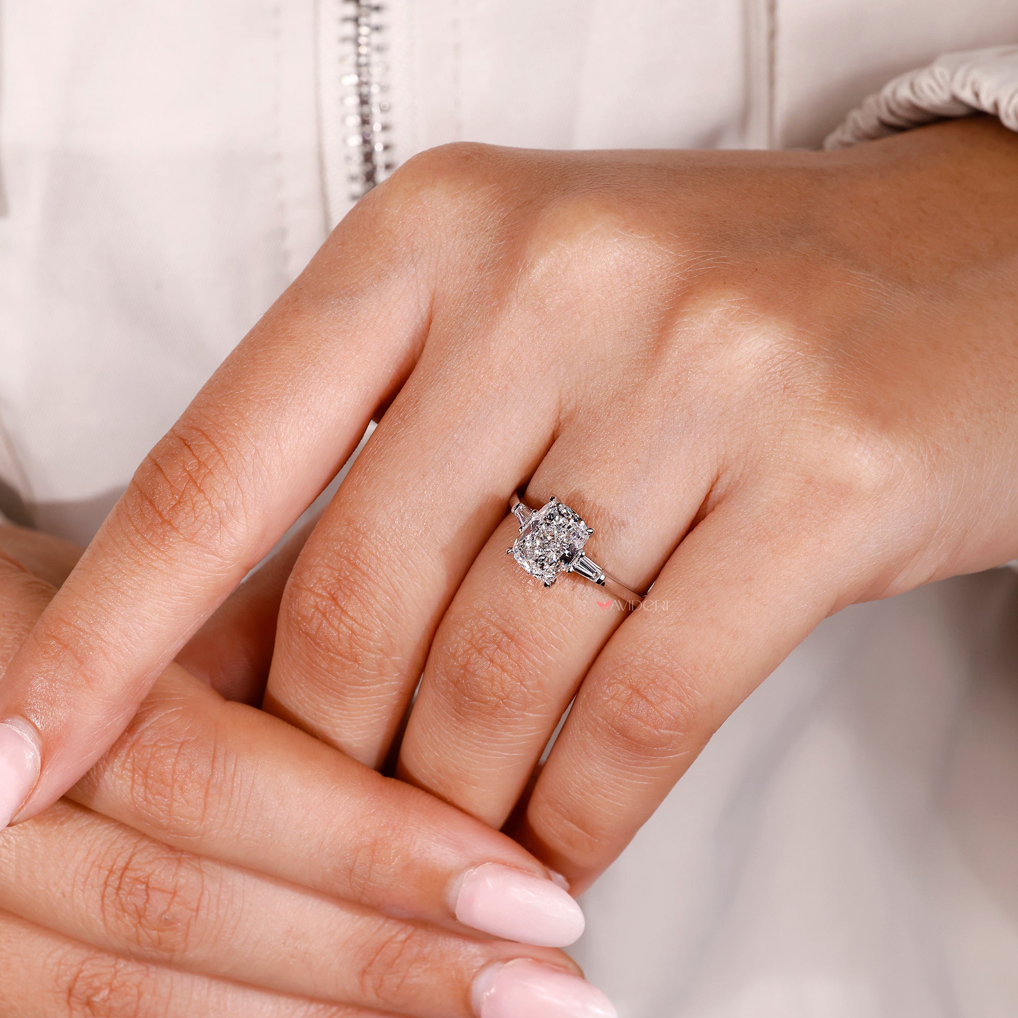 Tapered baguette side stones with cathedral setting ring.