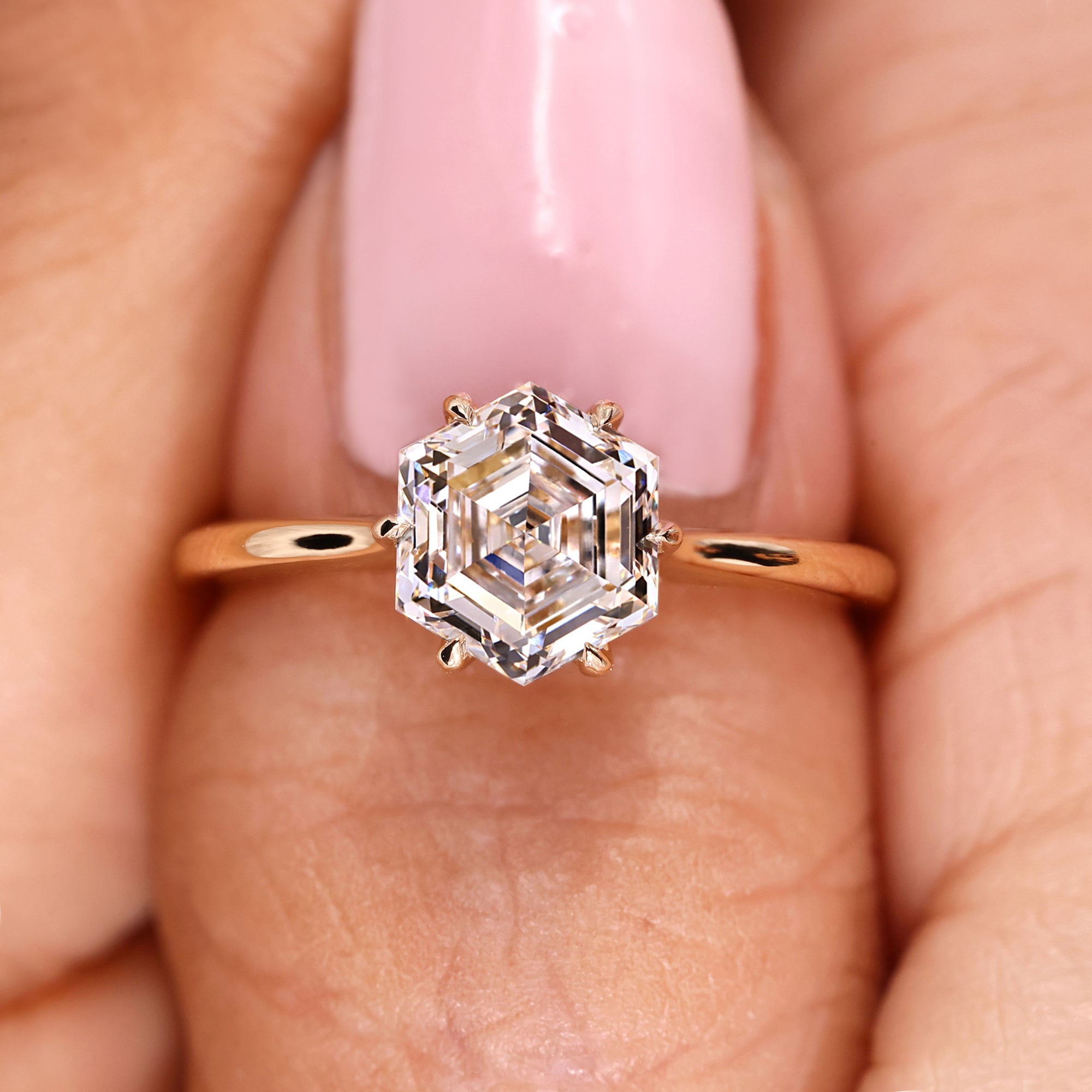 Yellow gold engagement ring and lab-grown diamond ring.