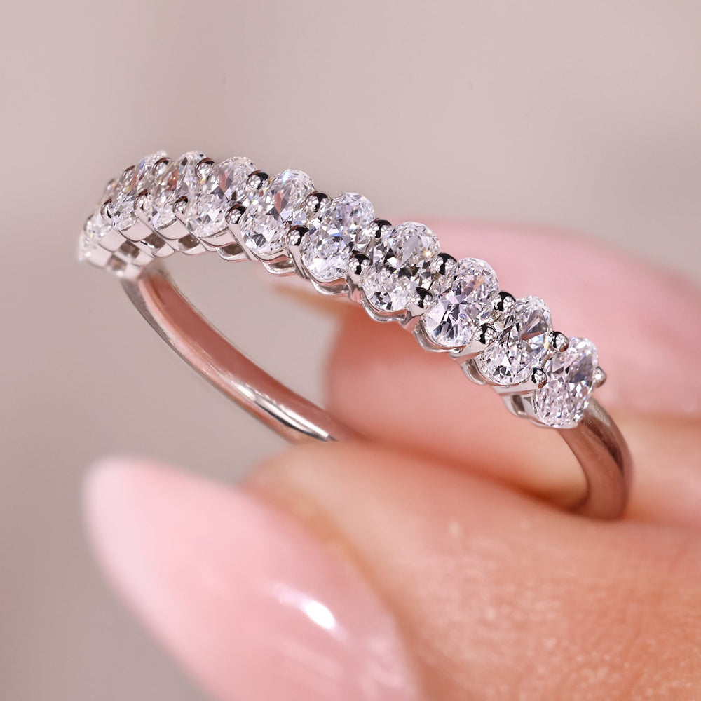 Oval cut diamond band with shared prong design.