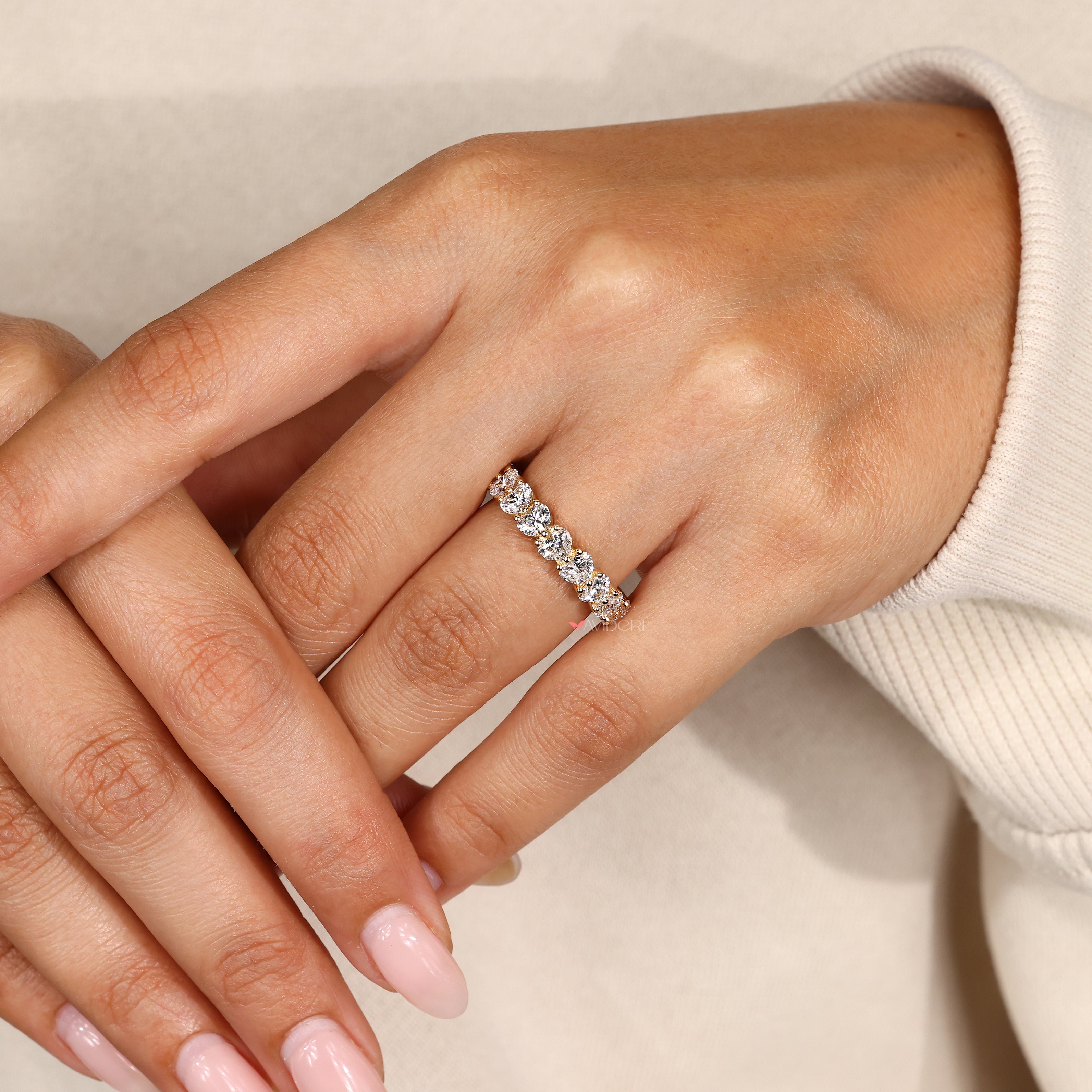 Heart cut eternity band with shared prong setting.
