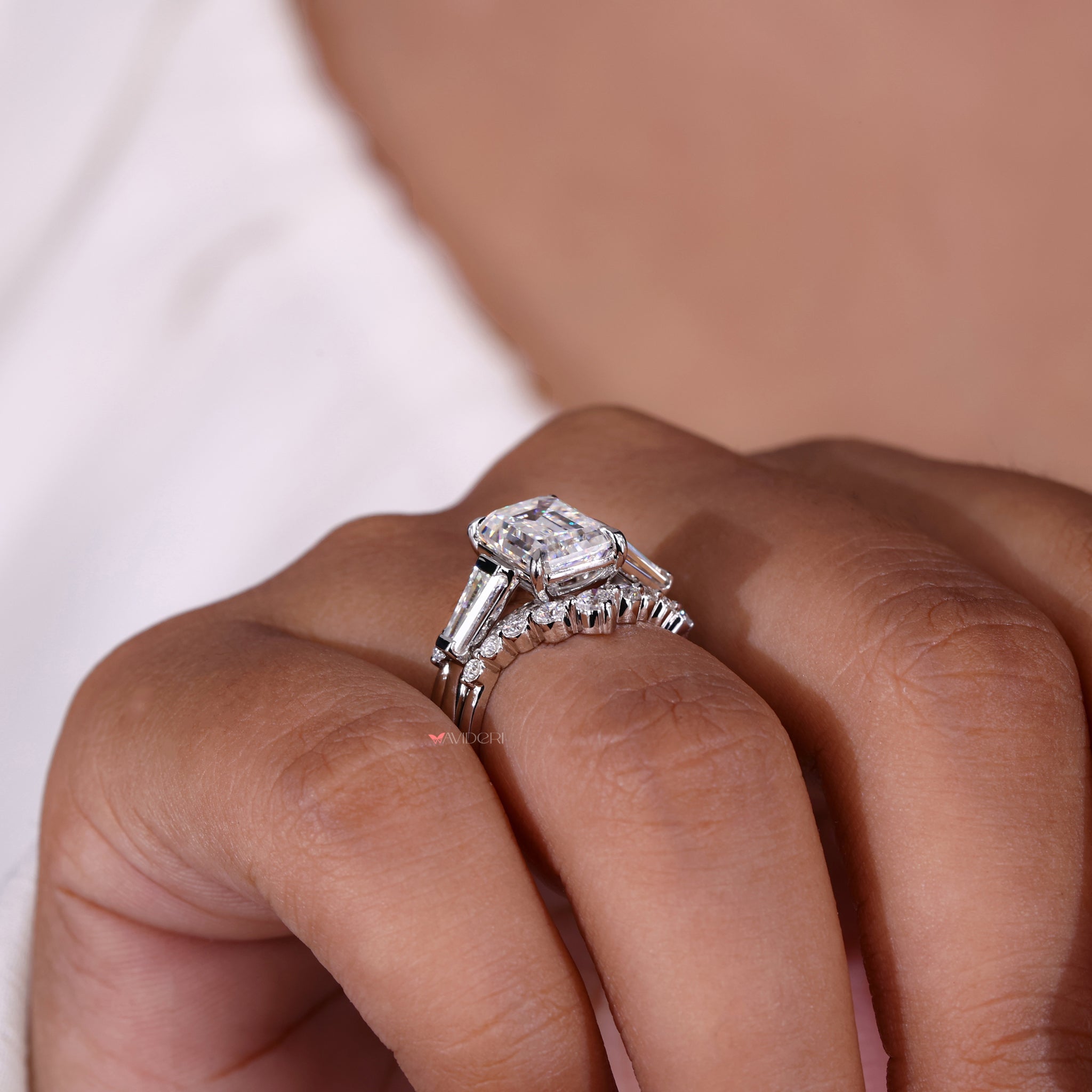 Shared prong moissanite wedding band design.