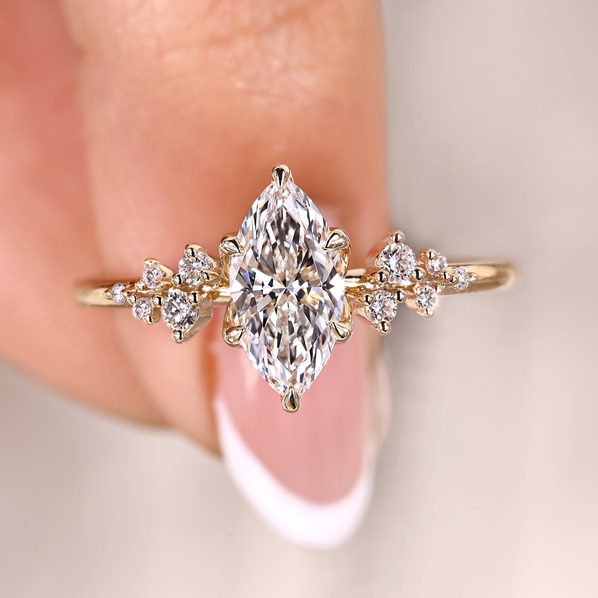 Marquise cut engagement ring with cluster diamond ring.