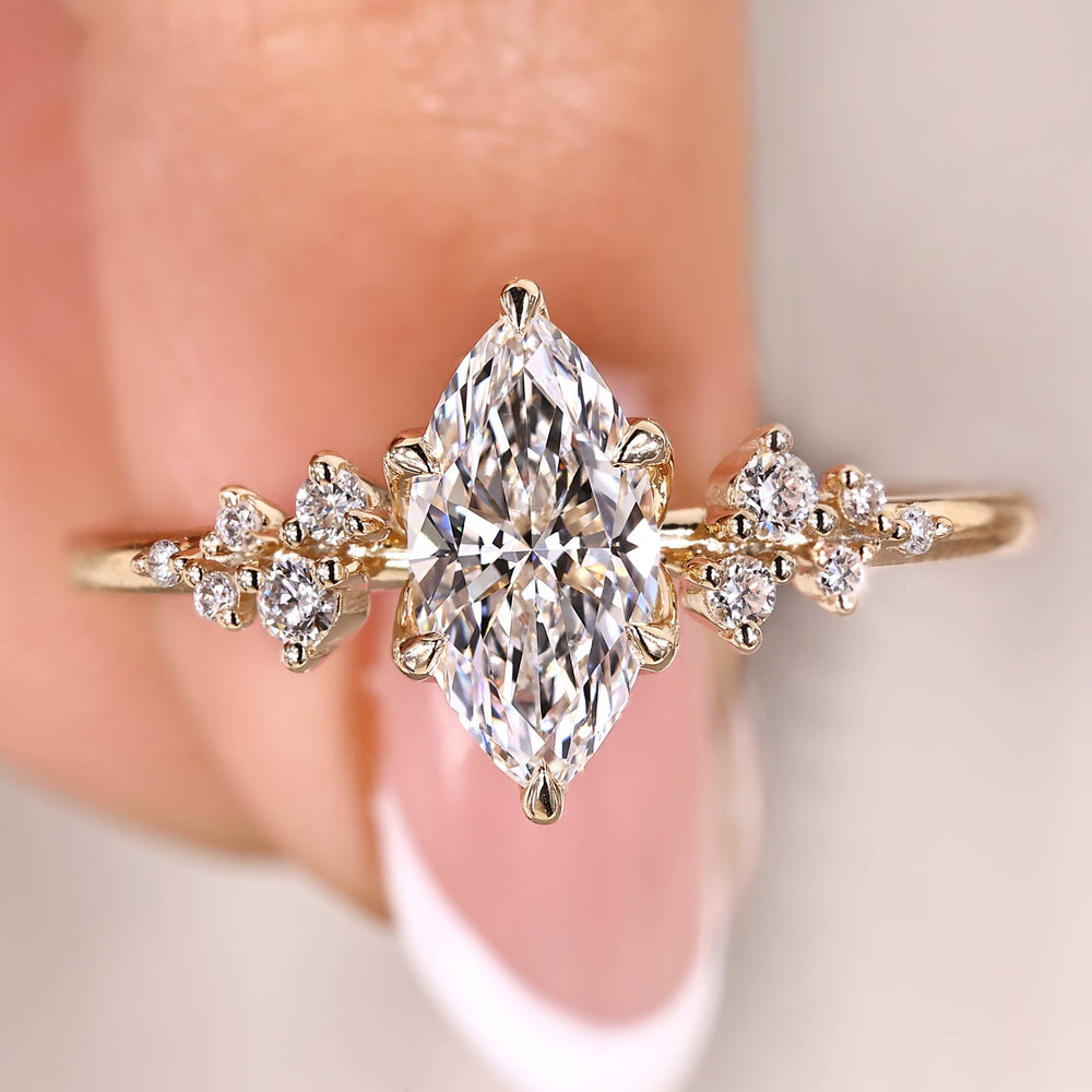 Marquise cut engagement ring with cluster diamond ring.