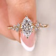 Marquise cut engagement ring with cluster diamond ring.