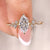 Marquise cut engagement ring with cluster diamond ring.